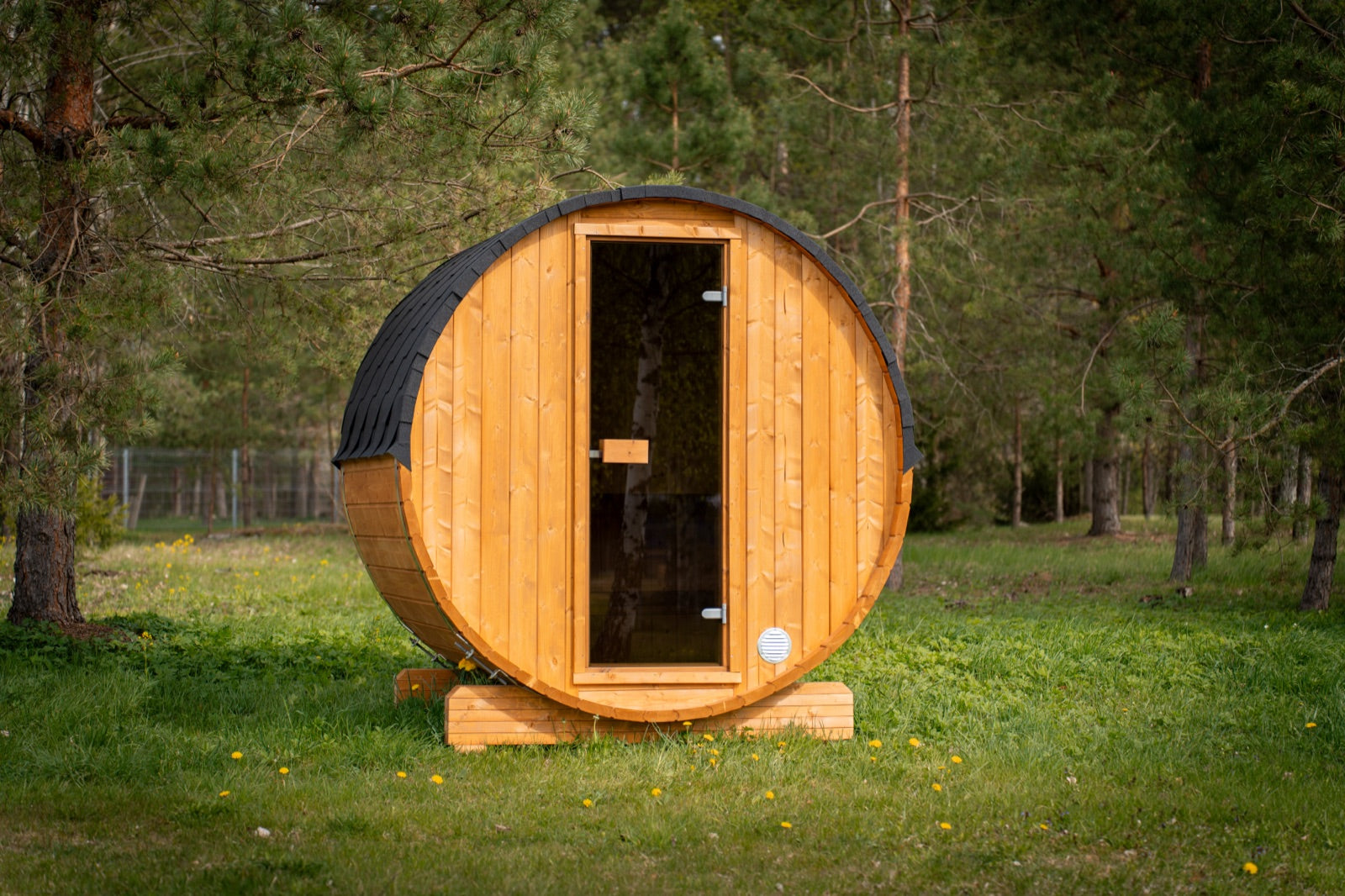 Cove Barrel sauna in natural timber among pines