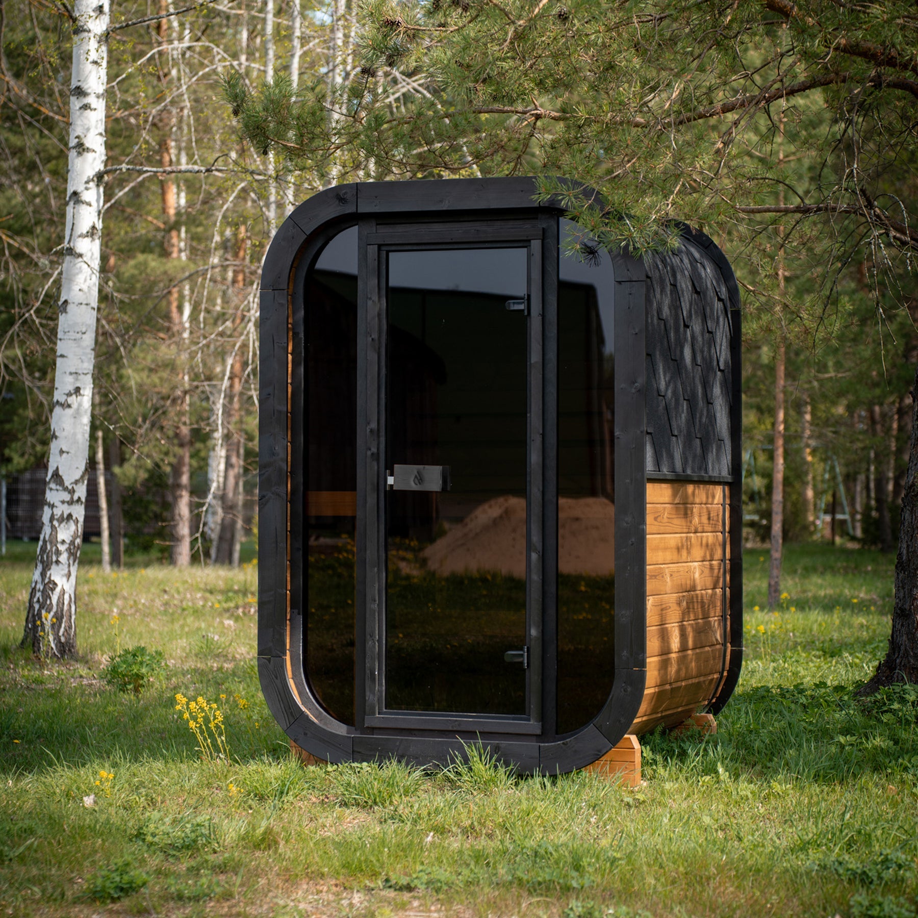 PlusLife Mini Traditional 2.0 sauna cabin in honey timber with a tinted glass front